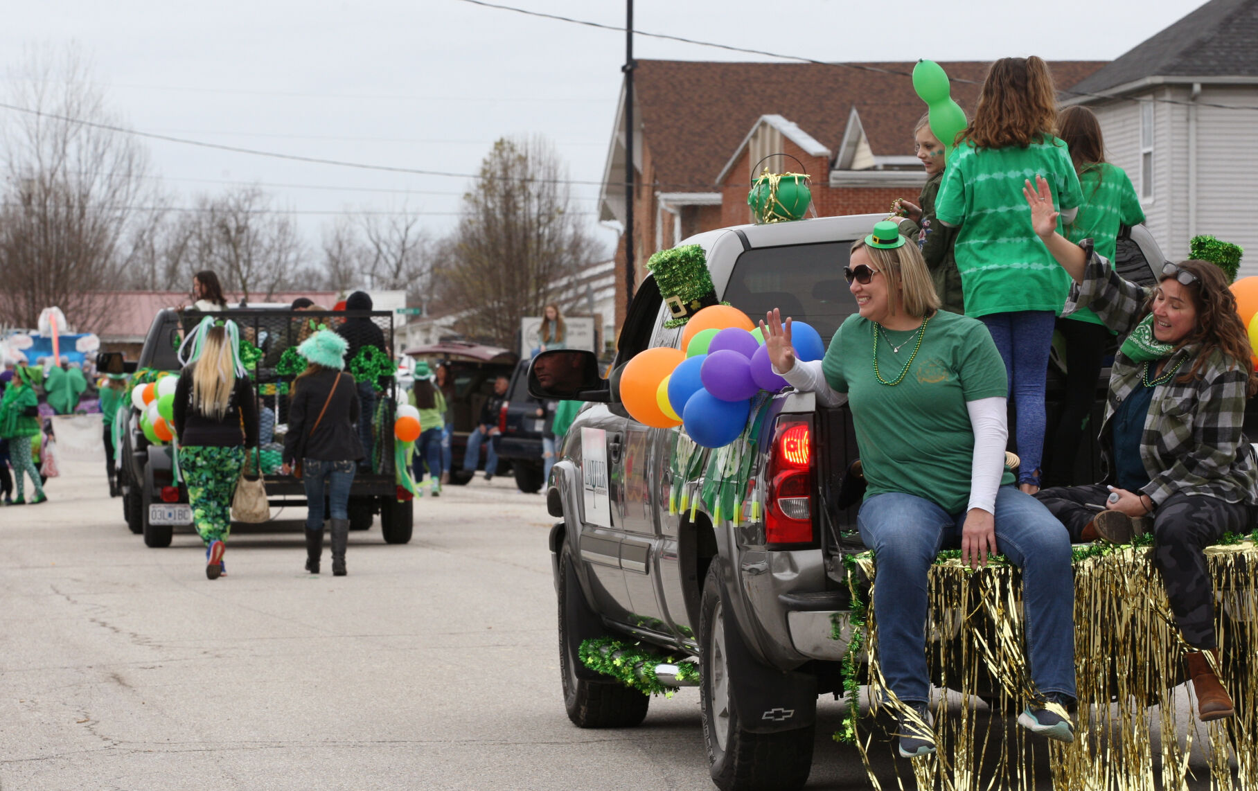 Participants in the parade wave